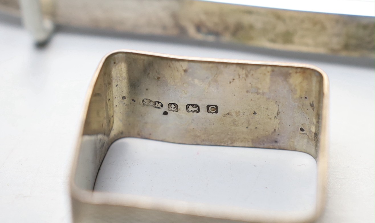 A George V small square silver dish by James Dixon & Sons and three silver napkin rings.